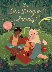 Cover of Tea Dragon Society. Three of our characters sit on a picnic blanket surrounded by greenery