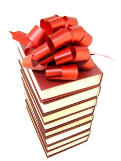 Stack of books with a gift bow on top