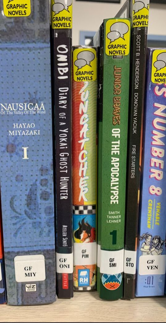 Spines of Graphic Fiction showing the new shelving scheme: GF AUT